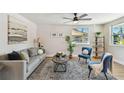 Bright living room features modern decor, a ceiling fan, and warm-toned wood flooring at 3540 Emerson S Ave, St Petersburg, FL 33711