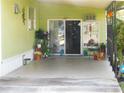 Enclosed carport area with sliding glass door entry at 36624 Kay Ave, Zephyrhills, FL 33542
