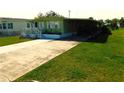 Single-story home with a long driveway and well-maintained green lawn at 36624 Kay Ave, Zephyrhills, FL 33542