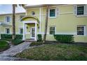Exterior view of condo features a welcoming front entrance with classic architectural details and manicured landscaping at 5196 Beach Se Dr # B, St Petersburg, FL 33705