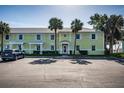 Charming condo complex shows a well-maintained yellow exterior with white trim, surrounded by palm trees at 5196 Beach Se Dr # B, St Petersburg, FL 33705