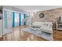 Bright living room featuring a brick accent wall, hardwood floors, and stylish decor at 6800 20Th N Ave # 309, St Petersburg, FL 33710