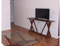 View of living room featuring a TV on a console table and laminate wood flooring at 8455 112Th St # 202, Seminole, FL 33772