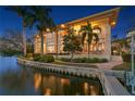 Expansive waterfront home featuring multiple balconies and a private dock, perfect for enjoying serene water views and outdoor living at 950 Monterey Ne Pt, St Petersburg, FL 33704