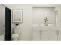 Bright bathroom featuring a double sink vanity with white cabinets and a shower with a dark curtain at 11856 Blue Diamond Trl, Parrish, FL 34219