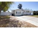 Single-story home offers a spacious driveway and a fenced yard, perfect for outdoor activities at 210 83Rd N Ave, St Petersburg, FL 33702