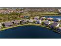 Aerial view of waterfront homes and landscaping, showcasing the lake and backyard views at 3248 Anchor Bay Trl, Bradenton, FL 34211