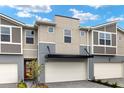 New townhouse featuring an attached two-car garage and front door at 3460 Timber Crossing Ave, Brandon, FL 33511