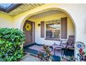 Inviting front porch with a decorative wreath, seating, and charming architectural details at 3479 Maclaren Dr, Palm Harbor, FL 34684