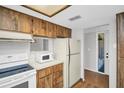 Kitchen featuring laminate floor, appliances, and cabinetry at 3479 Maclaren Dr, Palm Harbor, FL 34684