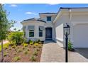 Charming single-Gathering home with a blue front door and well-maintained landscaping at 3575 Santa Caterina Blvd, Bradenton, FL 34211
