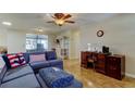 Comfortable living area with natural light, tile flooring, and a furniture set in the corner at 3805 Baden Dr, Holiday, FL 34691