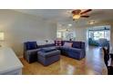 Cozy living room features tile flooring, a ceiling fan, and a comfortable sectional sofa at 3805 Baden Dr, Holiday, FL 34691