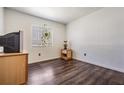 Cozy bedroom with dark laminate flooring, a window with shades, and neutral colored walls at 4126 Gradstone Pl, Tampa, FL 33617