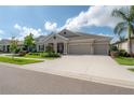 Beautiful single-Gathering home with a three-car garage, well-maintained lawn and manicured shrubbery at 6915 Sea Stone Ct, Apollo Beach, FL 33572