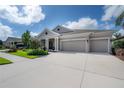 Attractive one-story home with a three car garage and large concrete driveway at 6915 Sea Stone Ct, Apollo Beach, FL 33572