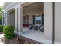 Inviting covered front porch with charming wicker chairs and a view of the double-door entrance at 6915 Sea Stone Ct, Apollo Beach, FL 33572