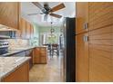 Well-lit kitchen features stainless steel appliances, granite countertops, and wooden cabinets at 711 S Oregon Ave, Tampa, FL 33606