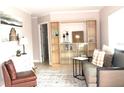 Inviting living room featuring a comfortable couch and stylish shelving at 12400 Park Blvd # 408, Seminole, FL 33772