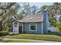 Charming home featuring an attached garage and mature landscaping at 14910 Northwood Village Ln, Tampa, FL 33613