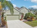Lovely home featuring a well-manicured lawn, beautiful landscaping, and an attached two-car garage at 1503 Yale Castle Ct, Ruskin, FL 33570
