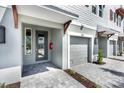 Townhome entryway with gray pavers, modern door, and one car garage at 1623 Sea Haven Dr # 307, Punta Gorda, FL 33950