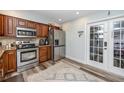 A kitchen with stainless steel appliances, granite counters, and wood cabinets at 1824 Clearbrooke Dr, Clearwater, FL 33760
