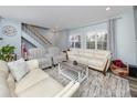 Bright living room featuring a cozy seating area, staircase, and plenty of natural light at 1824 Clearbrooke Dr, Clearwater, FL 33760