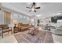 Comfortable living room with tile flooring, ceiling fan, and a traditional-style leather couch at 2082 Sifield Greens Way # 3, Sun City Center, FL 33573