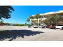Inviting exterior view of a multi-story building with palm trees and ample parking at 2222 Norwegian Dr # 24, Clearwater, FL 33763