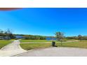 Scenic view of an outdoor park with a paved walkway, lush greenery, and water at 2222 Norwegian Dr # 24, Clearwater, FL 33763