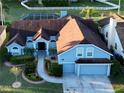 Stunning aerial view of home with mature landscaping, a backyard pool, and fenced yard at 2233 Golf Manor Blvd, Valrico, FL 33596