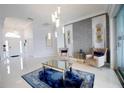 Modern living room featuring stylish decor, statement lighting, and porcelain tile flooring at 2233 Golf Manor Blvd, Valrico, FL 33596
