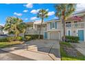 Charming two-story townhouse features an attached garage, lush landscaping, and inviting private entrance at 238 Sun Ketch Ct # 95, Treasure Island, FL 33706