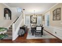 An inviting dining room featuring a staircase, stylish chandelier, and hardwood floors at 2915 W Bay View Ave, Tampa, FL 33611