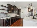 Modern kitchen featuring dark wood cabinets, stainless steel appliances, and quartz countertops at 2915 W Bay View Ave, Tampa, FL 33611