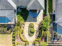 Aerial view of landscaped backyard featuring a stone patio and lush landscaping at 2923 Devonoak Blvd, Land O Lakes, FL 34638