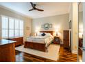 Comfortable bedroom with wooden furnishings, a ceiling fan, and plantation shutters at 2923 Devonoak Blvd, Land O Lakes, FL 34638