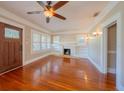 Cozy living room with hardwood floors, a decorative fireplace, and built-in shelving at 3007 W Angeles St, Tampa, FL 33629