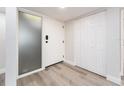 Bright entryway featuring light wood flooring, a large closet, and frosted sidelight at 3021 Countryside Blvd # 23A, Clearwater, FL 33761