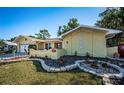Well-maintained single-story home featuring unique landscaping and decorative details enhancing its curb appeal at 3531 Glossy Ibis Ct, Palm Harbor, FL 34683