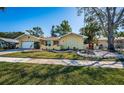 Inviting single-story home with lush landscaping and decorative fountain adding to its charming curb appeal at 3531 Glossy Ibis Ct, Palm Harbor, FL 34683