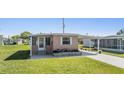 Single story home featuring covered parking and landscaped yard at 37246 Eileen Ave, Zephyrhills, FL 33542
