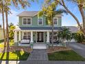 Charming two-story home with a cozy front porch, white pillars, and well-manicured lawn at 3749 Zachary St, New Port Richey, FL 34655