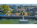Waterfront home featuring a private boat dock, waterfront access, and tropical landscaping at 4291 Flexer Dr, Hernando Beach, FL 34607