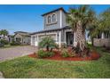 Charming two-story home with a paver driveway and well-manicured front yard at 4575 Tivoli Dr, Wesley Chapel, FL 33543