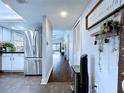 Inviting hallway with wood floors, neutral paint, and decor at 513 Hammock Pine Blvd, Clearwater, FL 33761