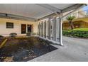 Assigned covered parking spot #15 with beige exterior condo buildings and lush greenery at 5920 80Th N St # 107, St Petersburg, FL 33709