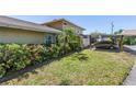 Charming home exterior featuring a well-maintained lawn and covered carport at 6902 El Centro Ct, Tampa, FL 33634