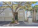 Attractive condo exterior with two garages and stairs leading to entrance and front yard trees at 732 Coral Reef Dr # 732, Tampa, FL 33602